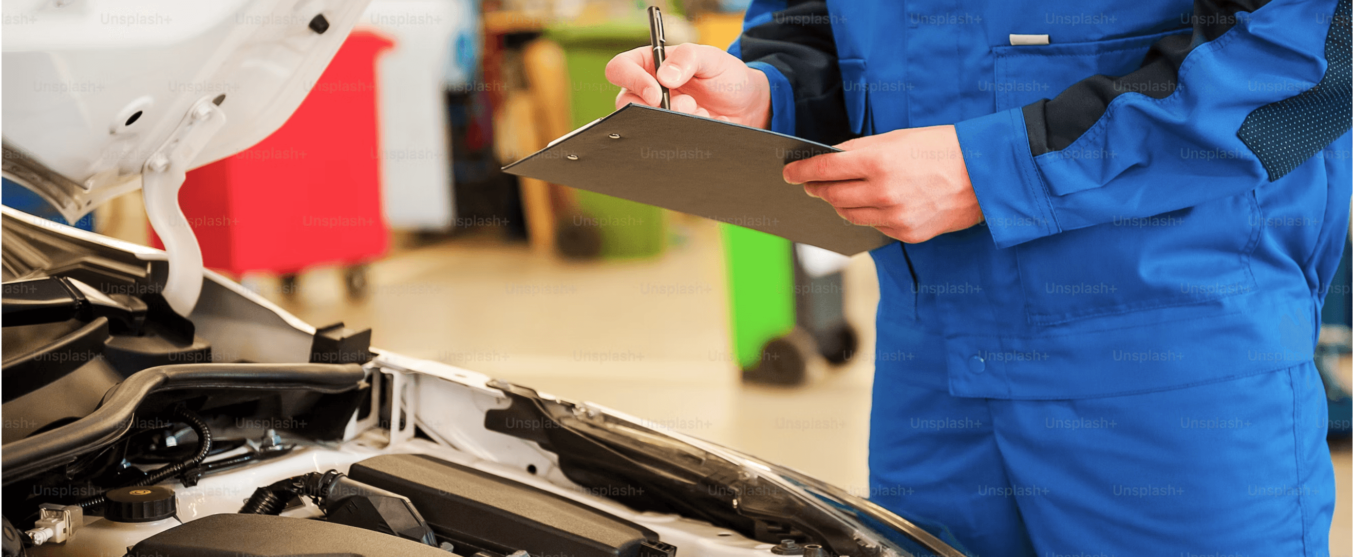 Technician reviewing a vehicle interior with a clipboard
